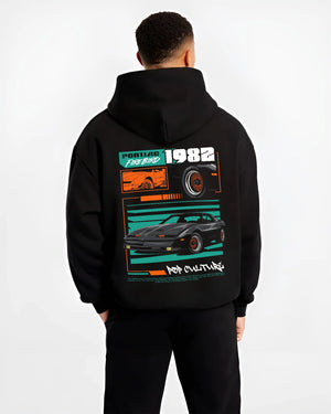 Black hoodie worn by a male model, back view, featuring Pontiac firebird trans am racing muscle street retro vintage graphic.
