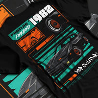Black T-shirt laid flat with natural fabric folds, featuring Pontiac firebird trans am racing muscle street retro vintage graphic.