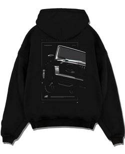 Black pullover hoodie laid flat on a white background, featuring Mercedes-Benz AMG rs racing street performance motorsport graphic.