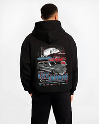 Black hoodie worn by a male model, back view, featuring Chevrolet retro vintage classic enthusiast show racing street graphic.