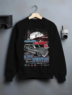 Black crewneck sweatshirt on a hanger against a grey wall, featuring Chevrolet retro vintage classic enthusiast show racing graphic.