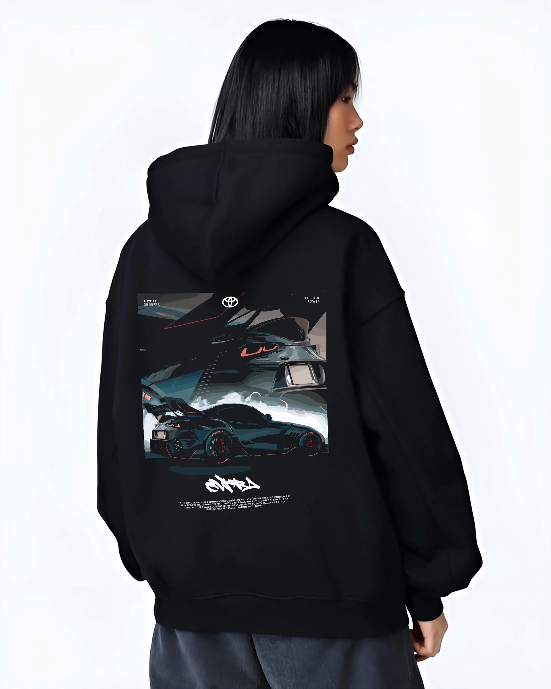 Black hoodie worn by a female model, back view, featuring Toyota Supra turbo turbocharged racing drift jdm japanese tuner graphic.