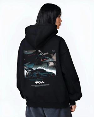 Black hoodie worn by a female model, back view, featuring Toyota Supra turbo turbocharged racing drift jdm japanese tuner graphic.