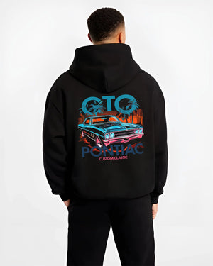 Black hoodie worn by a male model, back view, featuring Pontiac GTO muscle street retro vintage classic enthusiast graphic.