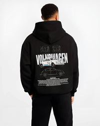 Black hoodie worn by a male model, back view, featuring Volkswagen Beetle racing classic legend street performance graphic.