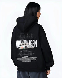 Black hoodie worn by a female model, back view, featuring Volkswagen Beetle racing classic legend street performance graphic.