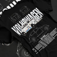Black T-shirt laid flat with natural fabric folds, featuring Volkswagen Beetle racing classic legend street performance graphic.