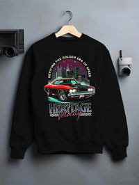 Black crewneck sweatshirt on a hanger against a grey wall, featuring Dodge Charger muscle retro racing street performance graphic.