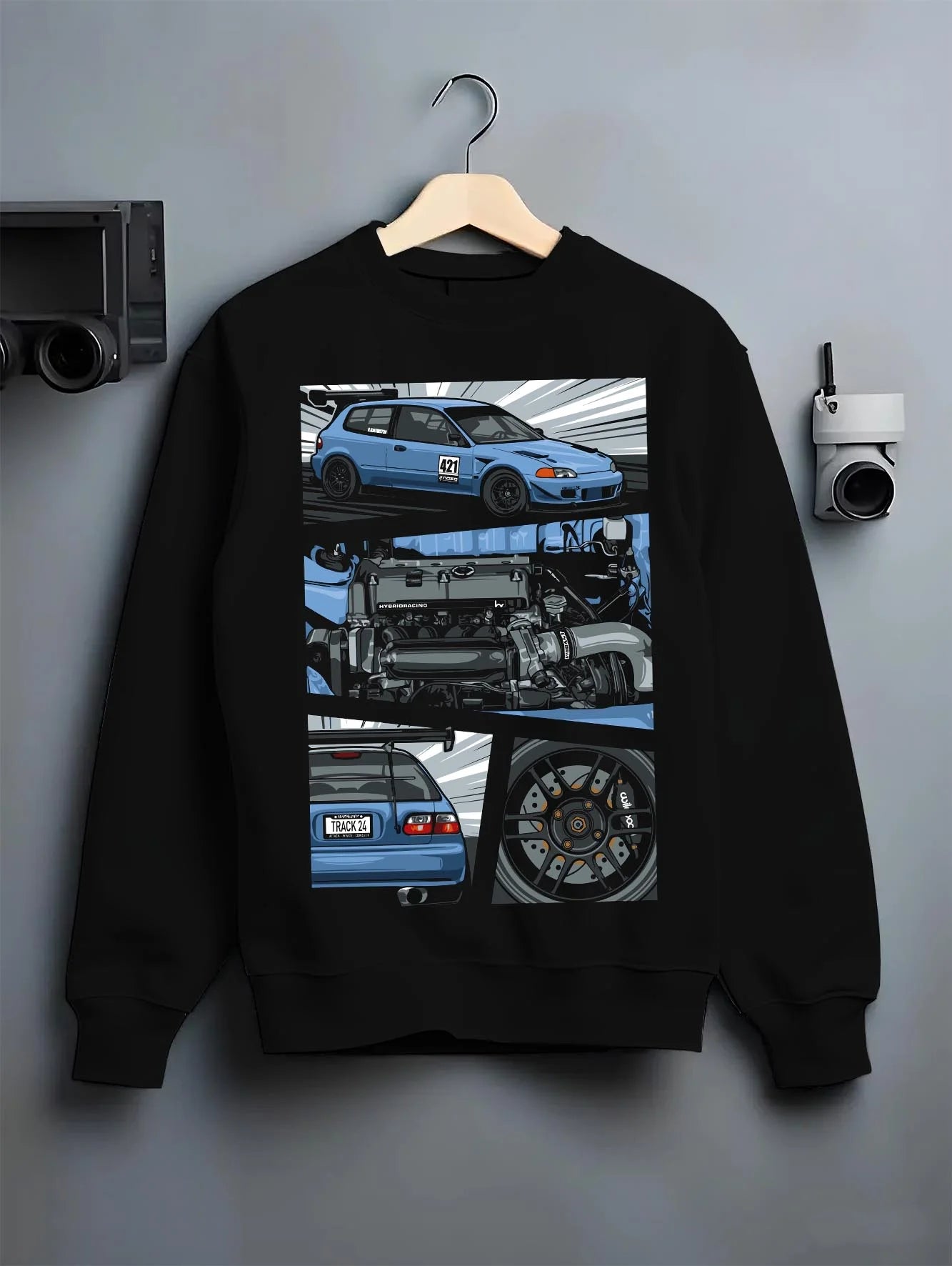 Black crewneck sweatshirt on a hanger against a grey wall, featuring Honda Civic racing track jdm japanese street graphic.