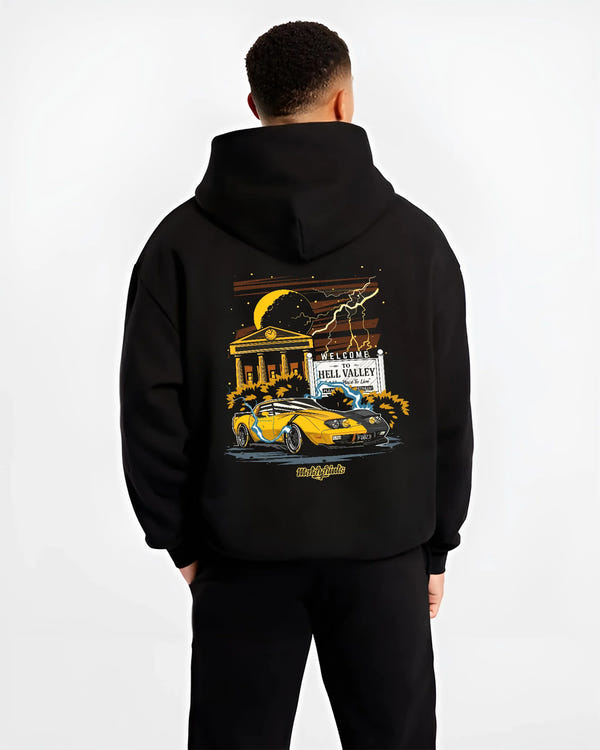 Black hoodie worn by a male model, back view, featuring racing street retro performance motorsport automotive enthusiast graphic.