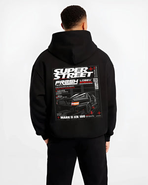 Black hoodie worn by a male model, back view, featuring Toyota JZX100 turbo drift street racing performance motorsport graphic.