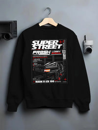 Black crewneck sweatshirt on a hanger against a grey wall, featuring Toyota JZX100 turbo drift street racing performance graphic.