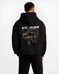 Black hoodie worn by a male model, back view, featuring KTM rs racing street performance motorsport automotive enthusiast graphic.