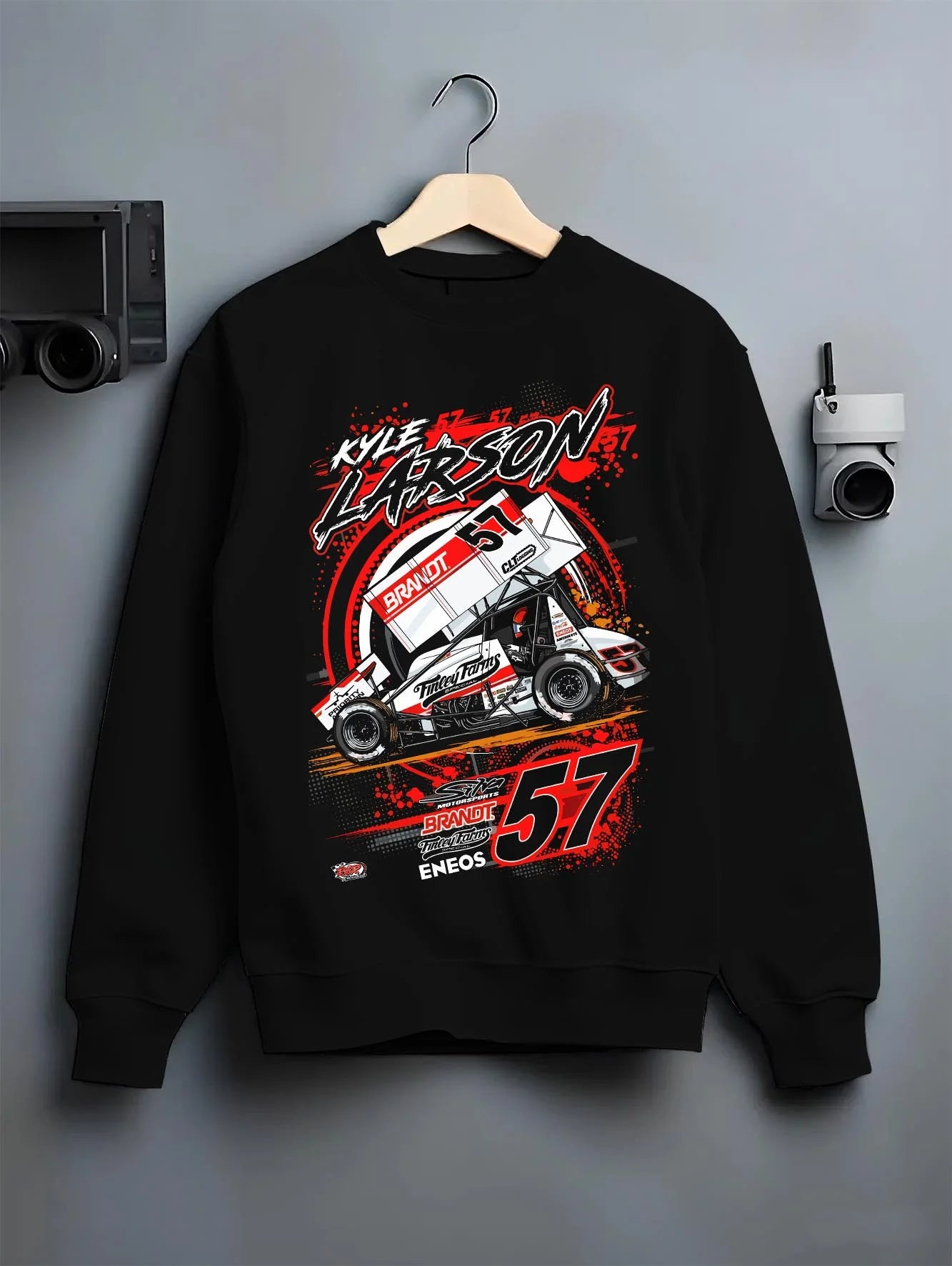 Black crewneck sweatshirt on a hanger against a grey wall, featuring rs racing motorsport speed street performance graphic.