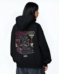 Black hoodie worn by a female model, back view, featuring drift drifting japanese tuner lowered street racing performance graphic.