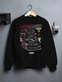 Black crewneck sweatshirt on a hanger against a grey wall, featuring drift drifting japanese tuner lowered street racing graphic.