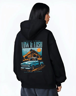 Black hoodie worn by a female model, back view, featuring Chevrolet retro classic racing street performance motorsport graphic.