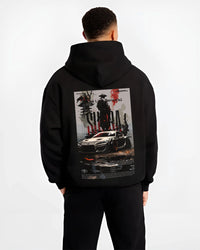 Black hoodie worn by a male model, back view, featuring Toyota Supra racing jdm japanese tuning street enthusiast graphic.