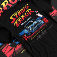 Black T-shirt laid flat with natural fabric folds, featuring Lexus racing drift tuner street enthusiast performance graphic.