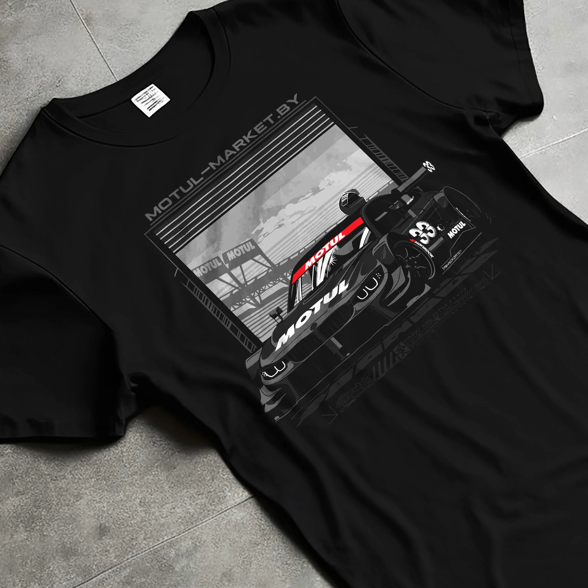 Black T-shirt laid flat with natural fabric folds, featuring BMW M4 rs turbo racing motorsport german street graphic.