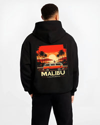 Black hoodie worn by a male model, back view, featuring retro vintage racing street performance motorsport automotive graphic.