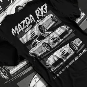 Black T-shirt laid flat with natural fabric folds, featuring Mazda RX--7 rx 7 racing drift jdm japanese street graphic.
