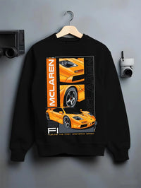 Black crewneck sweatshirt on a hanger against a grey wall, featuring McLaren 720S rs racing enthusiast street performance graphic.