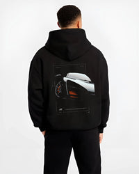 Black hoodie worn by a male model, back view, featuring McLaren F1 rs racing street retro speed enthusiast graphic.