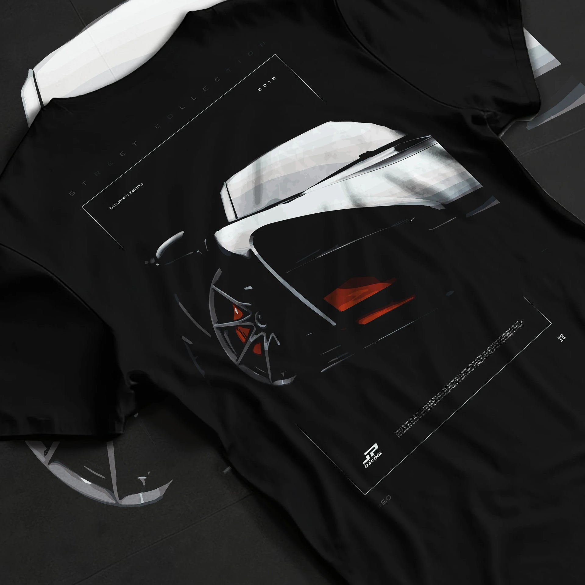 Black T-shirt laid flat with natural fabric folds, featuring McLaren F1 rs racing street retro speed enthusiast graphic.