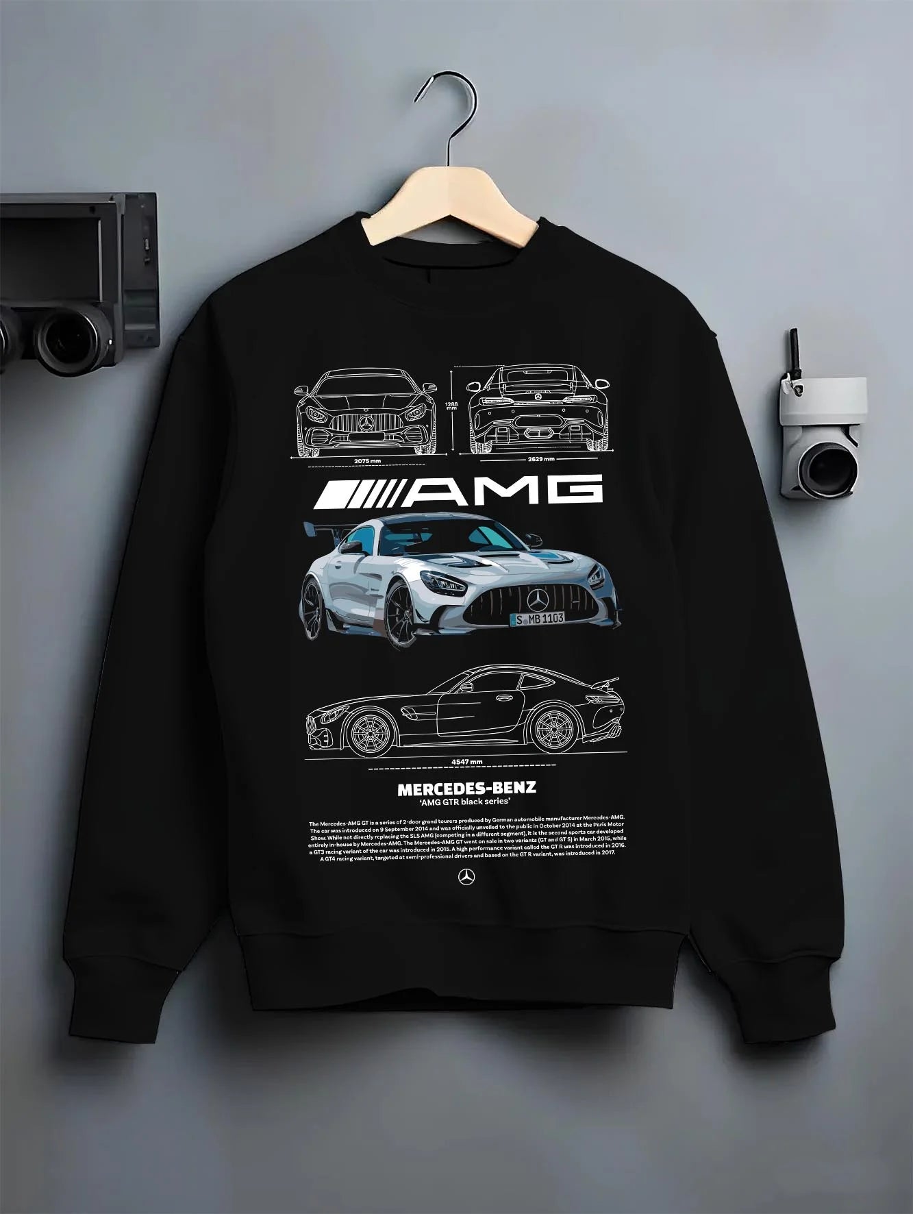 Black crewneck sweatshirt on a hanger against a grey wall, featuring Mercedes-Benz AMG rs racing motorsport street merc9.