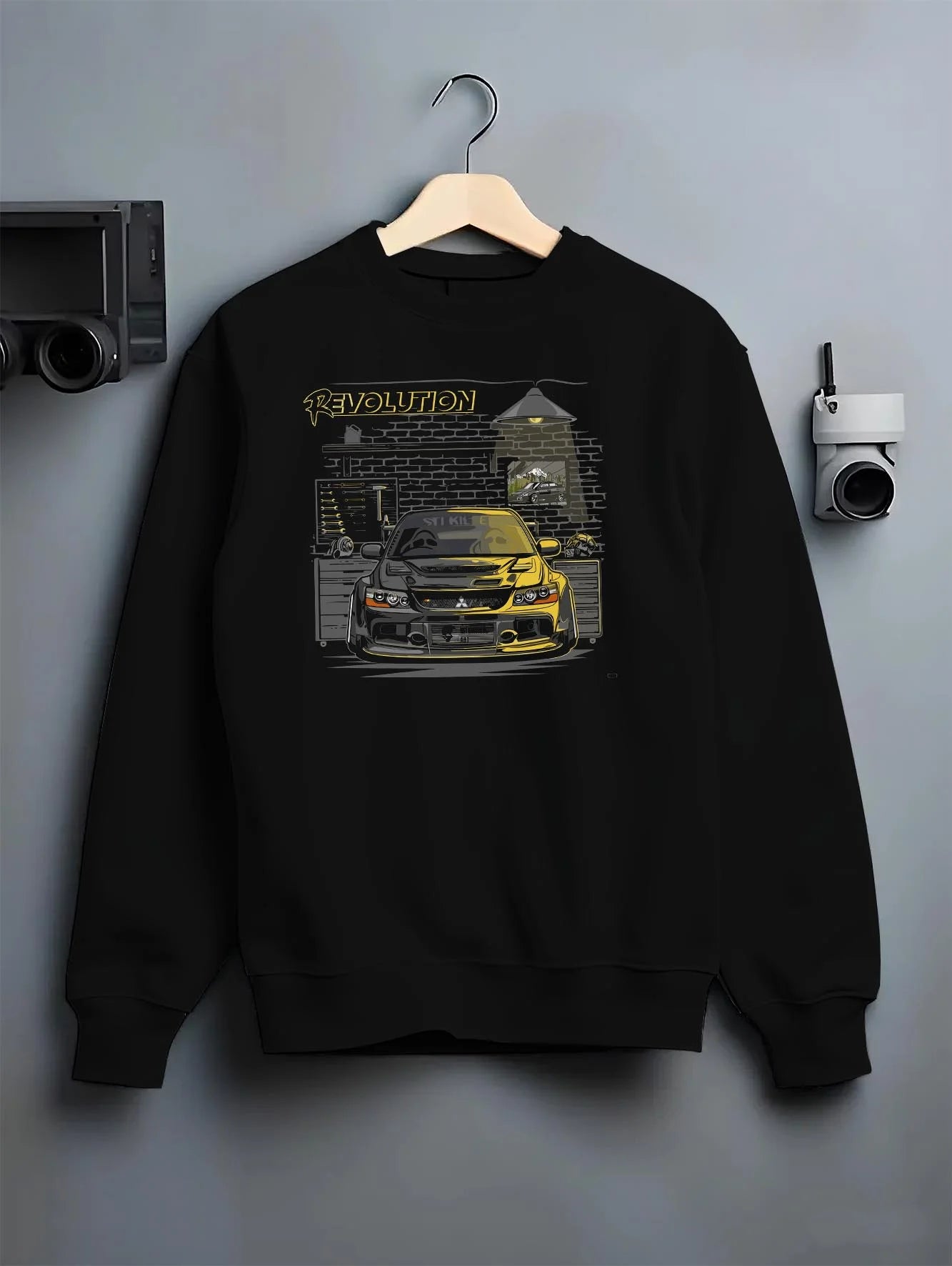Black crewneck sweatshirt on a hanger against a grey wall, featuring SKYLINE street retro racing performance motorsport graphic.