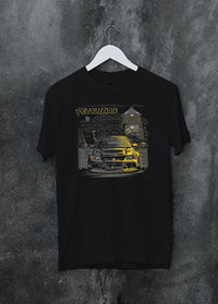 Black crewneck T-shirt on a hanger against a grey wall, featuring SKYLINE street retro racing performance motorsport graphic.