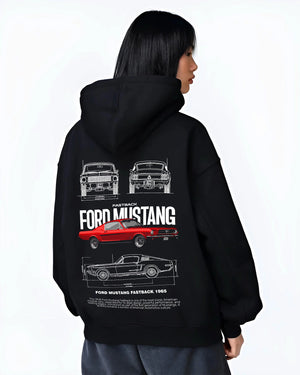 Black hoodie worn by a female model, back view, featuring Ford Mustang american muscle retro classic enthusiast racing graphic.