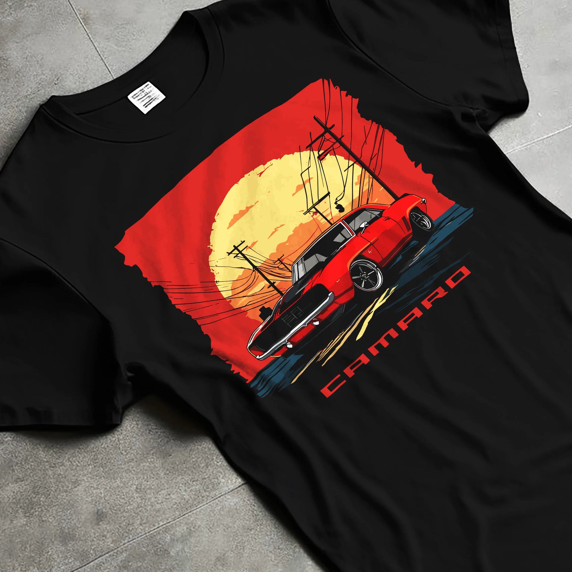 Black T-shirt laid flat with natural fabric folds, featuring racing drag american muscle street vintage classic performance graphic.