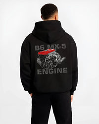 Black hoodie worn by a male model, back view, featuring Mazda MX-5 jdm tuner street racing performance motorsport graphic.