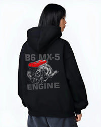 Black hoodie worn by a female model, back view, featuring Mazda MX-5 jdm tuner street racing performance motorsport graphic.