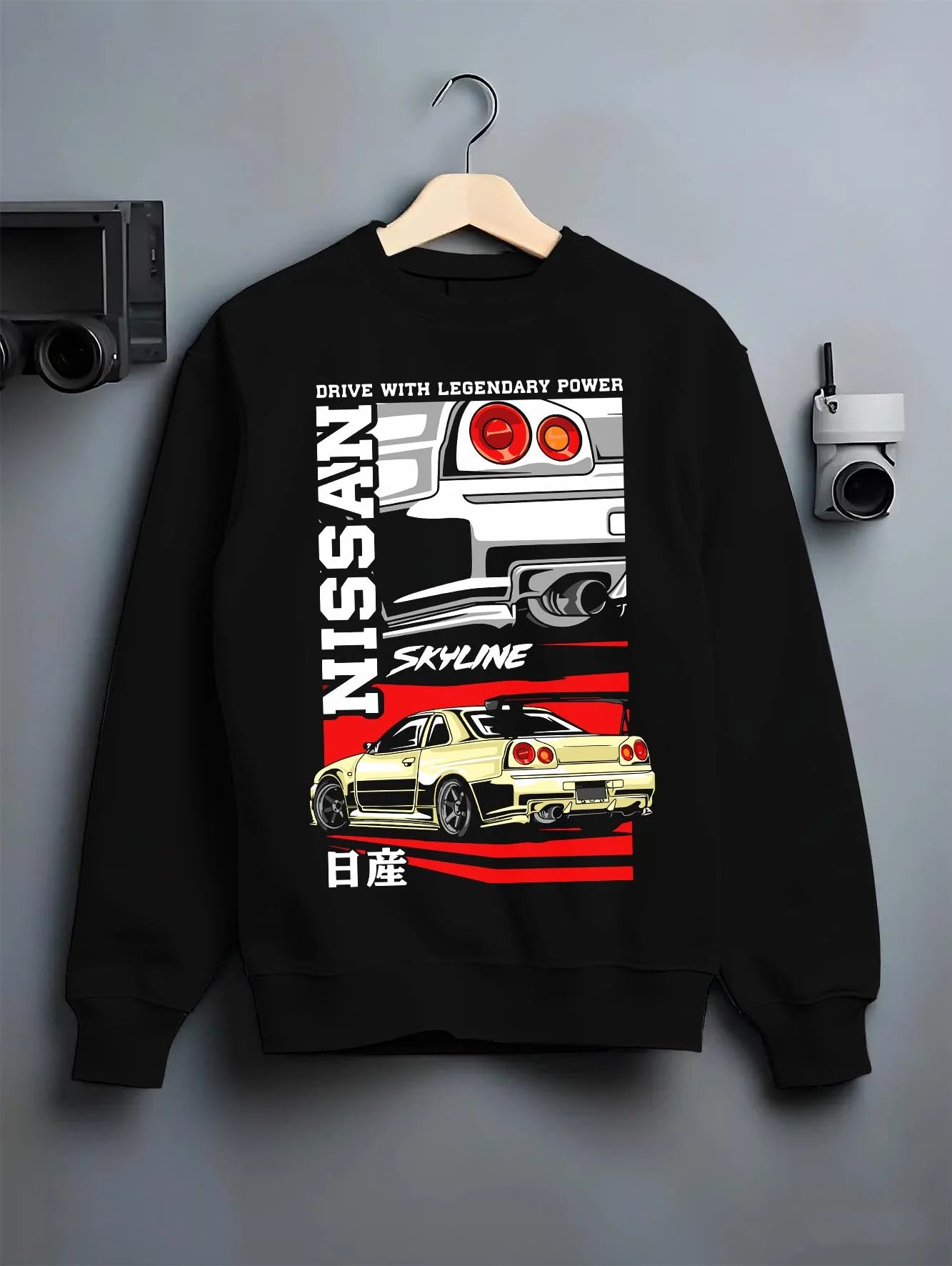 Black crewneck sweatshirt on a hanger against a grey wall, featuring Nissan Skyline R34 r34 skyline turbo drift jdm racing graphic.