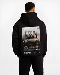 Black hoodie worn by a male model, back view, featuring Nissan GT-R R35 gt r r35 turbo racing street legend graphic.