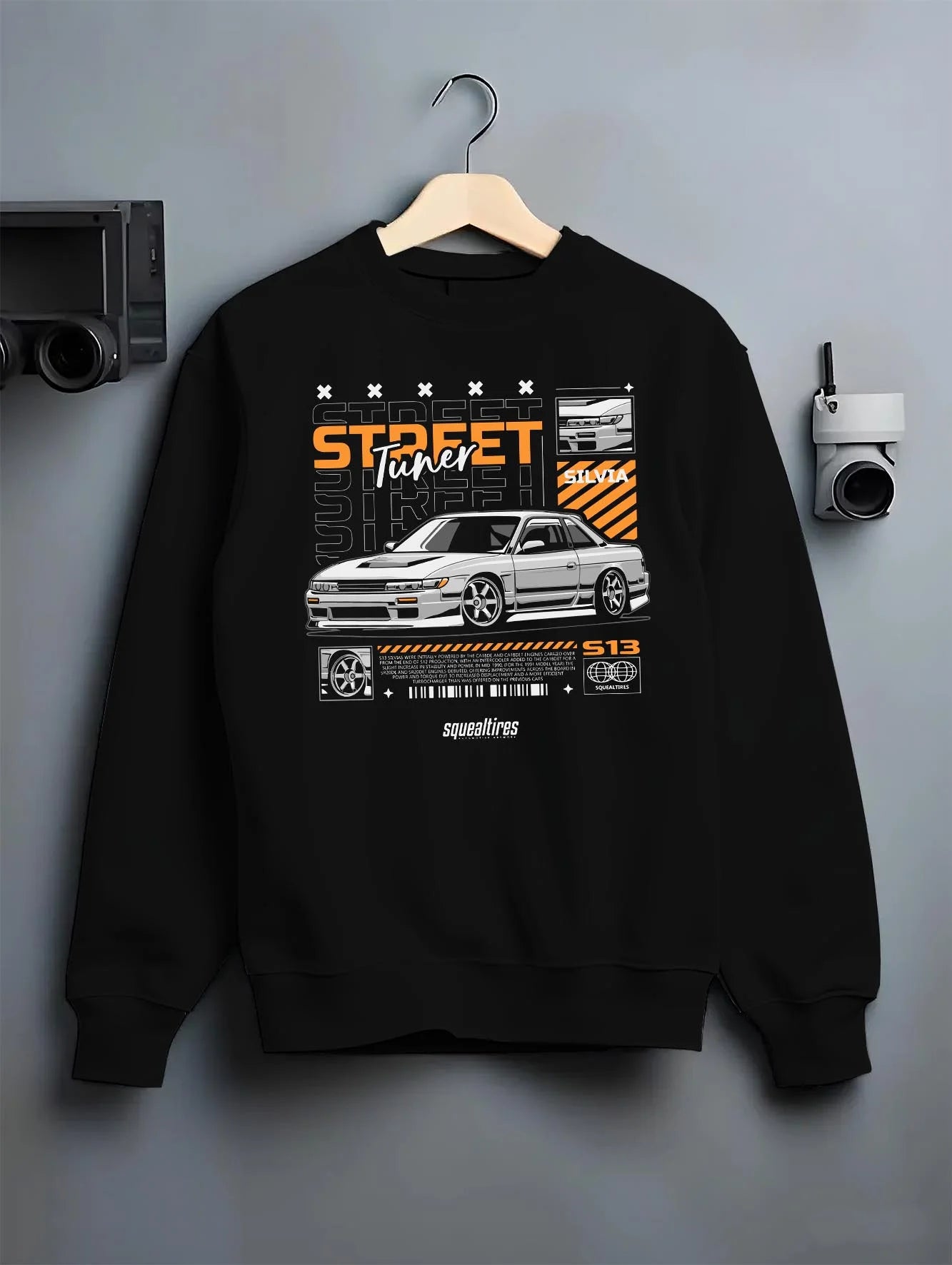 Black crewneck sweatshirt on a hanger against a grey wall, featuring Nissan Silvia S15 silvia turbo turbocharged racing graphic.