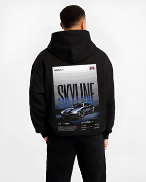 Black hoodie worn by a male model, back view, featuring Nissan Skyline R34 gt r r34 skyline rb26 jdm legend graphic.