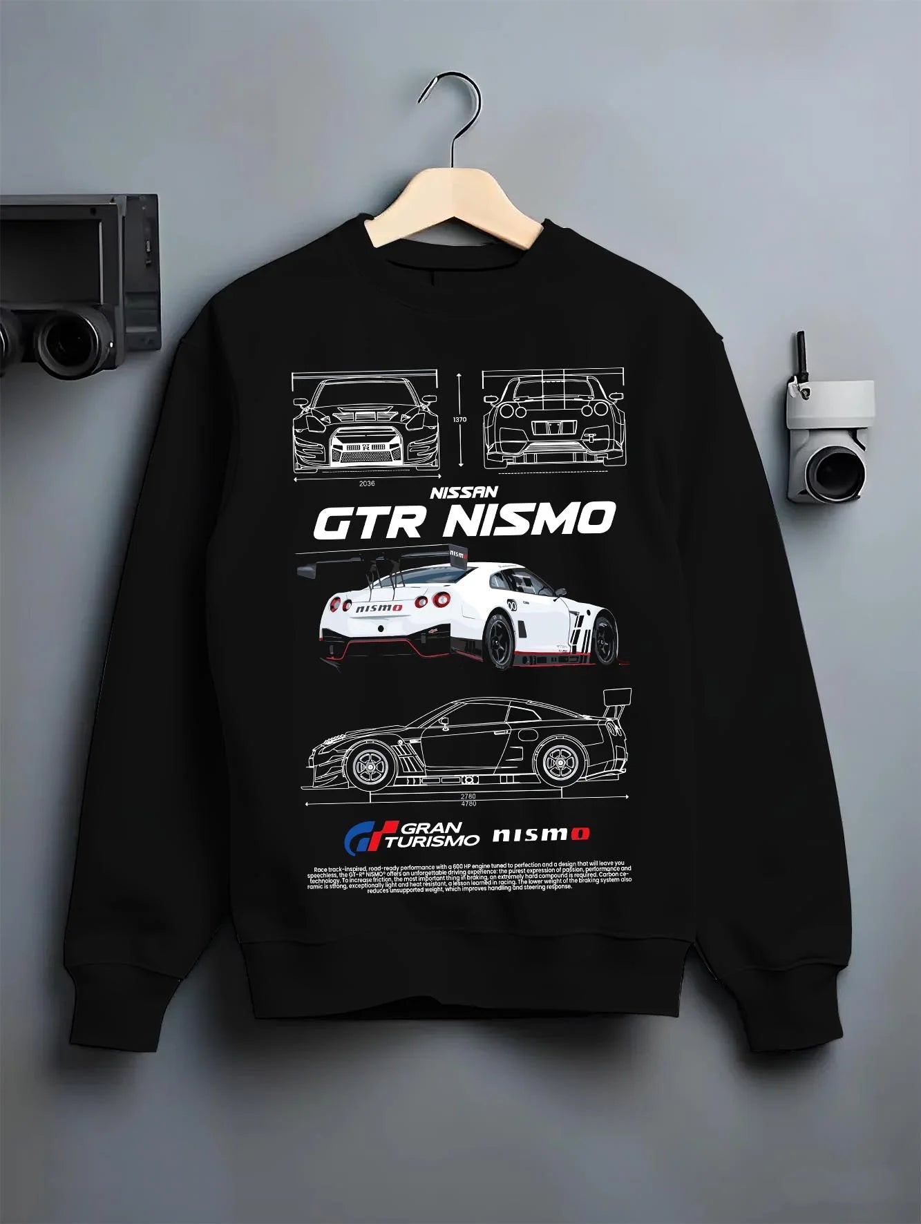 Black crewneck sweatshirt on a hanger against a grey wall, featuring Nissan Skyline R34 gtr r34 skyline turbo turbocharged nis7.