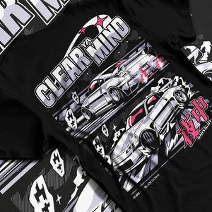 Black T-shirt laid flat with natural fabric folds, featuring Nissan race drift jdm japanese tuner street midnight graphic.
