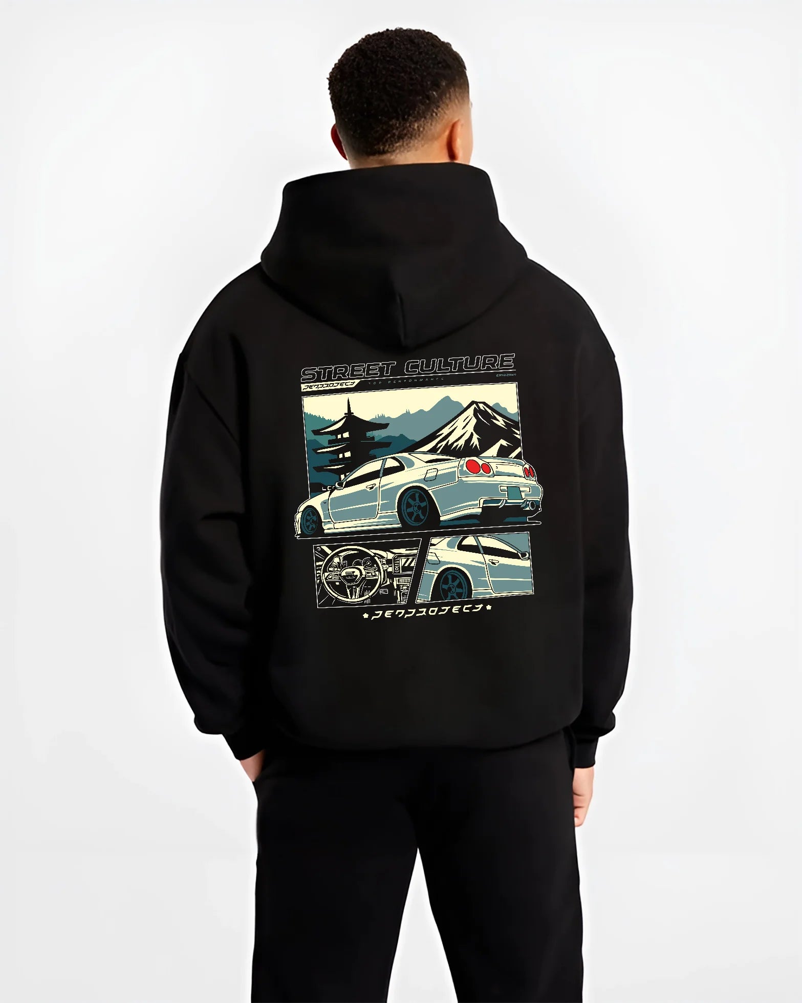 Black hoodie worn by a male model, back view, featuring Nissan Skyline drift jdm japanese tuner street retro graphic.