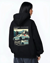 Black hoodie worn by a female model, back view, featuring Nissan Skyline drift jdm japanese tuner street retro graphic.