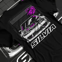Black T-shirt laid flat with natural fabric folds, featuring Nissan Silvia S15 silvia turbo drift jdm tuner street graphic.