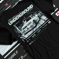 Black T-shirt laid flat with natural fabric folds, featuring Nissan 240SX rs turbo racing drift jdm japanese street classic graphic.