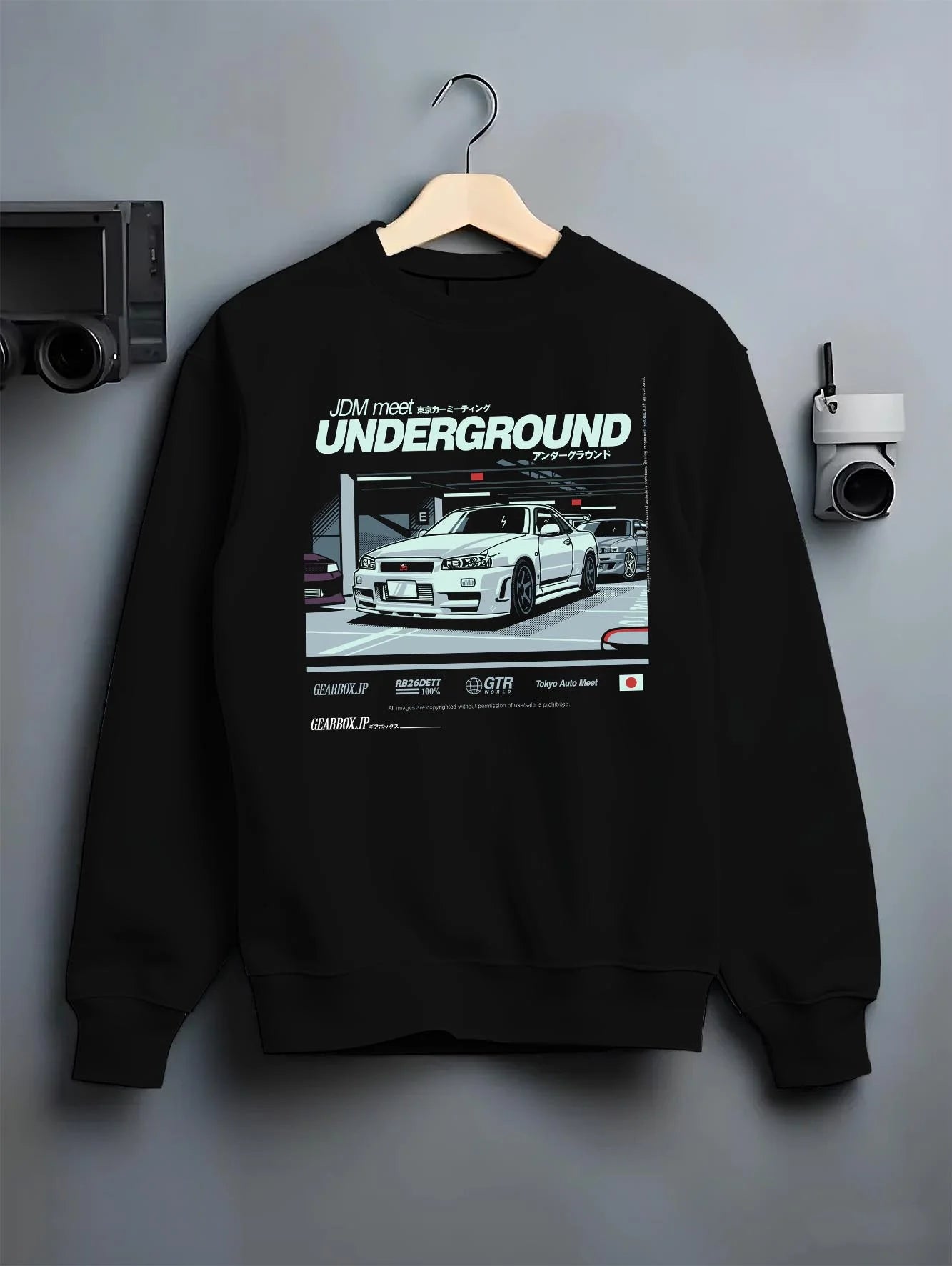 Black crewneck sweatshirt on a hanger against a grey wall, featuring Nissan 240SX rs turbo racing drift jdm japanese street graphic.
