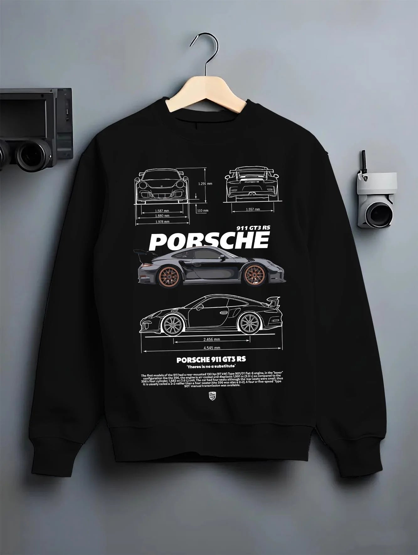 Black crewneck sweatshirt on a hanger against a grey wall, featuring Porsche 911 GT3 RS gt3 rs 911 racing motorsport street graphic.
