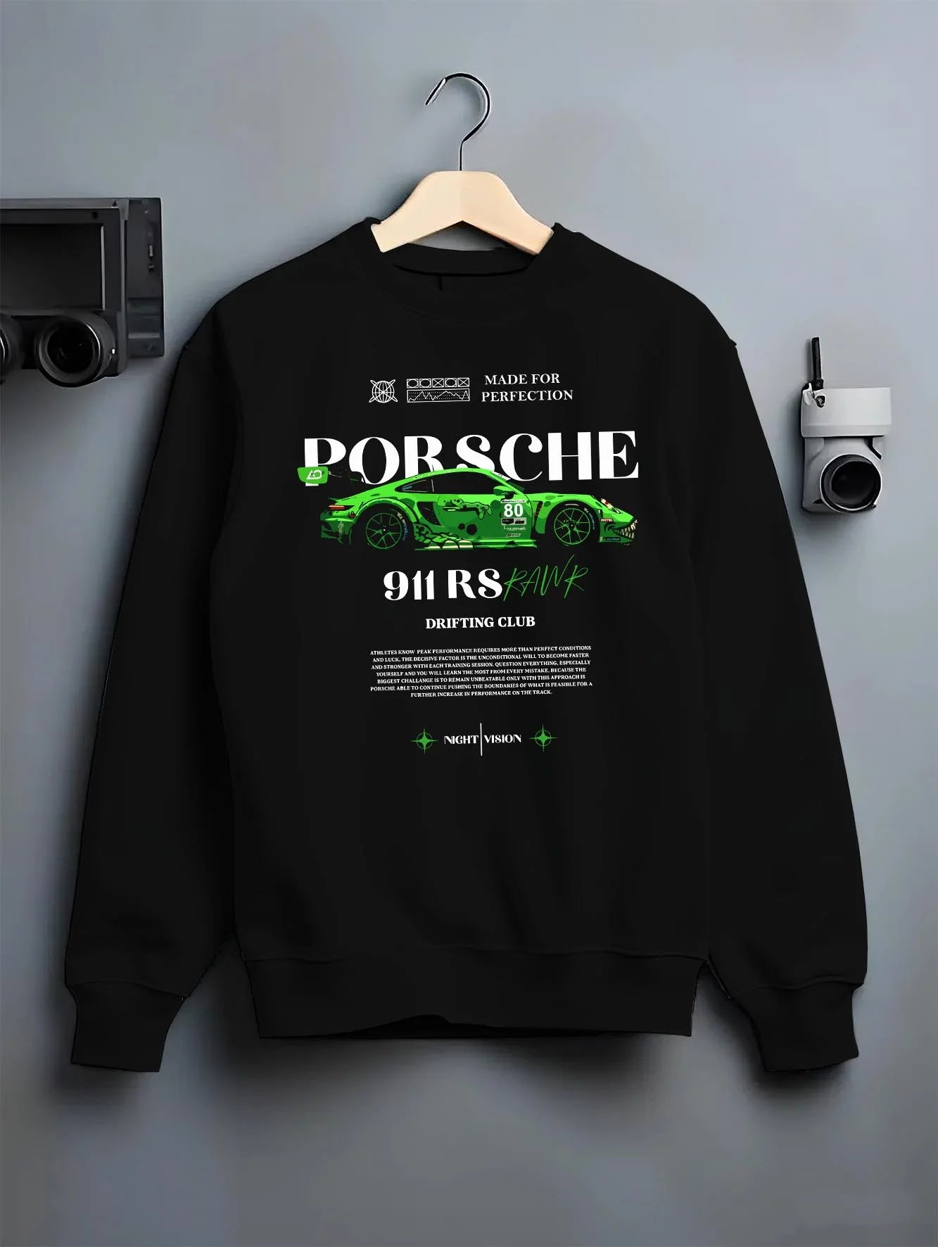 Black crewneck sweatshirt on a hanger against a grey wall, featuring Porsche 911 rs racing drift motorsport japanese street graphic.