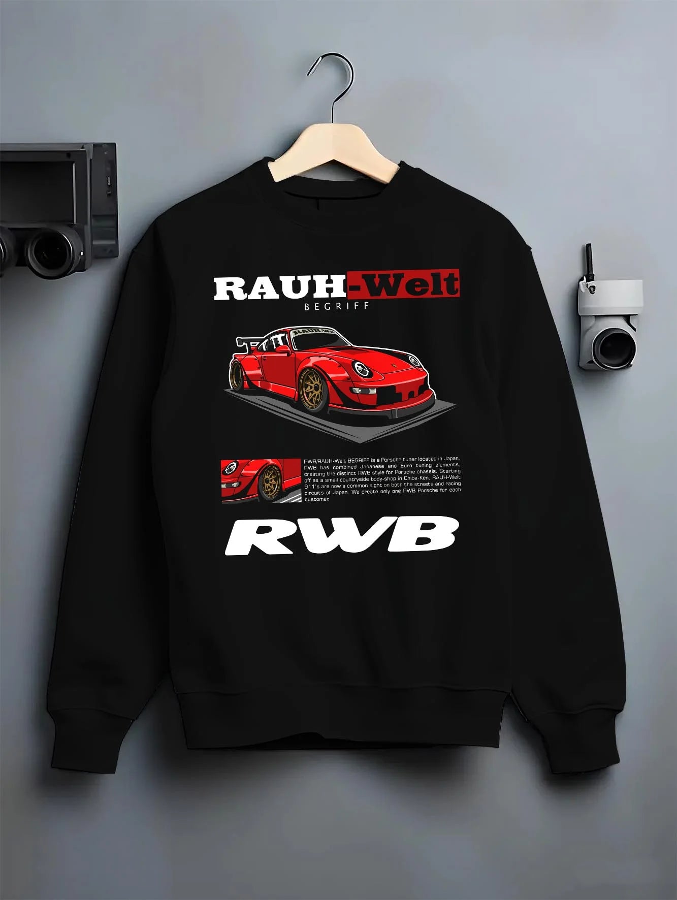 Black crewneck sweatshirt on a hanger against a grey wall, featuring Porsche 911 rs turbo turbocharged racing german tuner graphic.